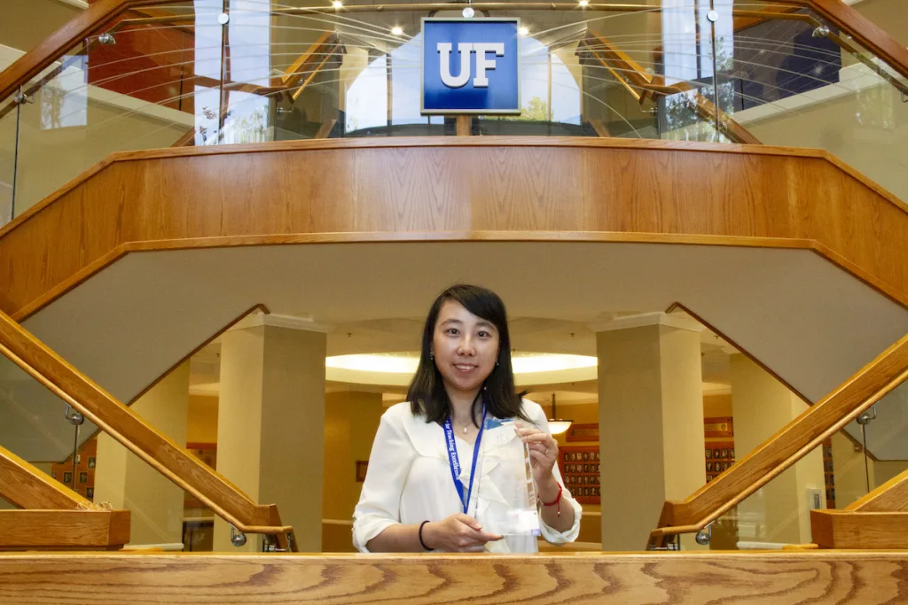 Dr. Ruogu Fang with award