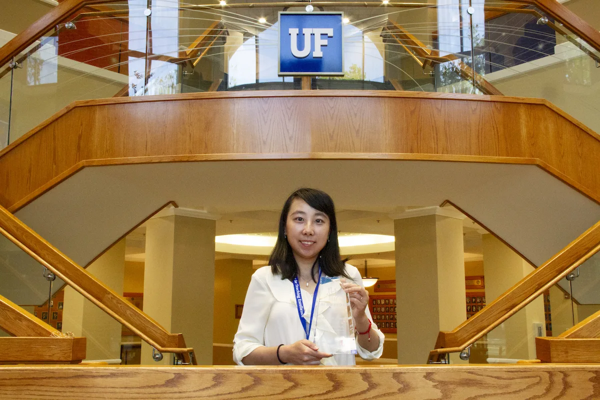 Dr. Ruogu Fang with award