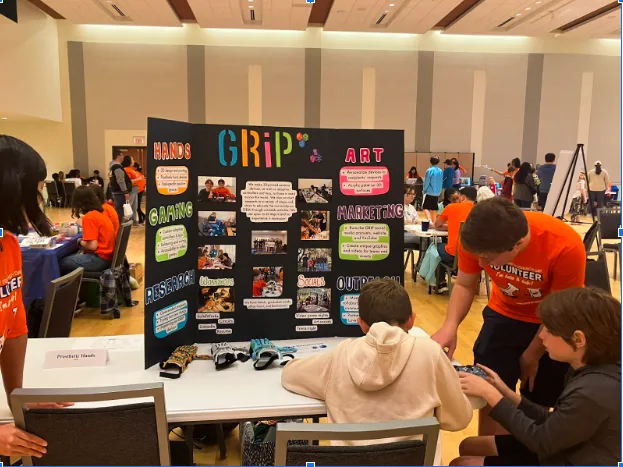 Volunteer students at UF BME Stem Outreach event at booth