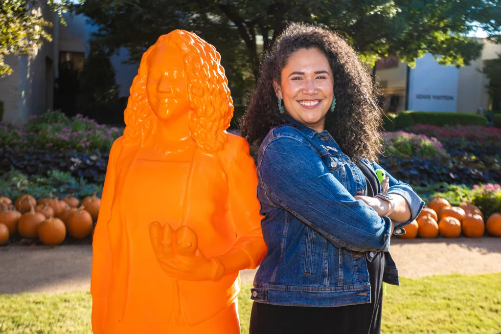 Dr. Ana Maria Porras standing near her statue